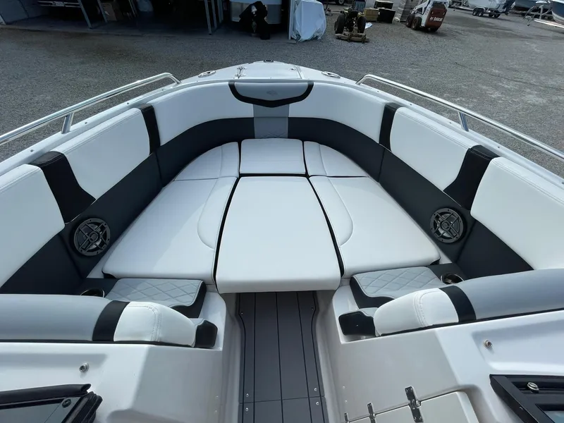 Slide: The Image of 2025 Chaparral 270 OSX boat interior with cushioned seating and speakers. - 17