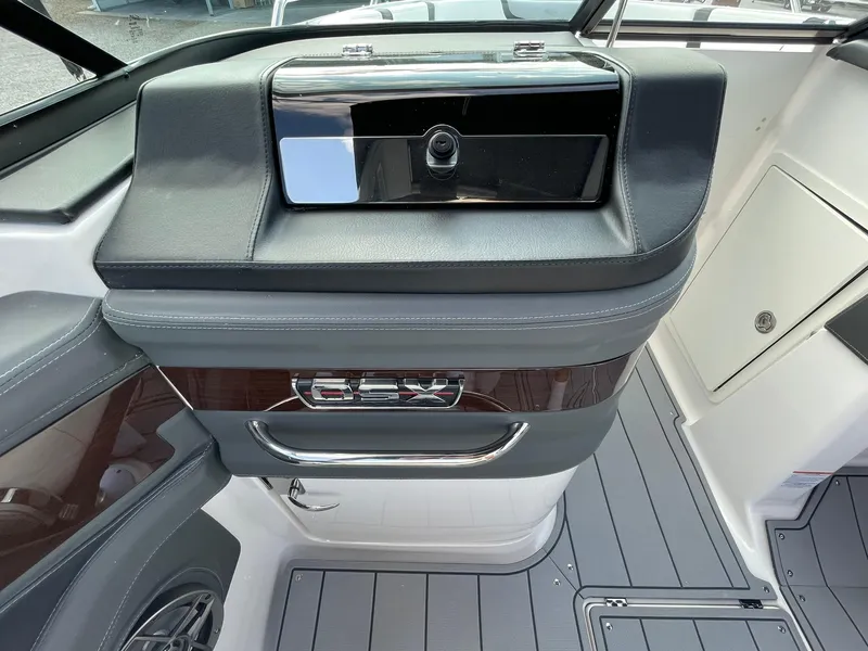Slide: The Image of 2025 Chaparral 270 OSX boat interior dashboard with sleek design and modern controls. - 20