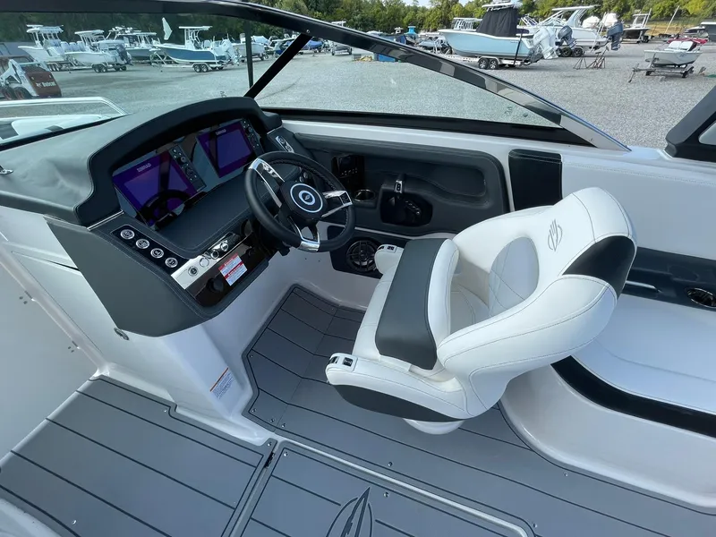 Slide: The Image of 2025 Chaparral 270 OSX boat cockpit with modern steering and dual displays. - 24