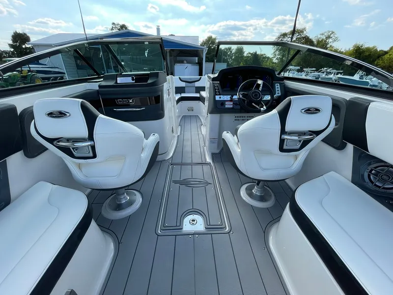 Slide: The Image of 2025 Chaparral 270 OSX boat interior with sleek seating and modern dashboard. - 35