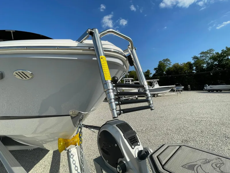 Slide: The Image of Chaparral 270 OSX 2025 boat on trailer under clear blue sky. - 7