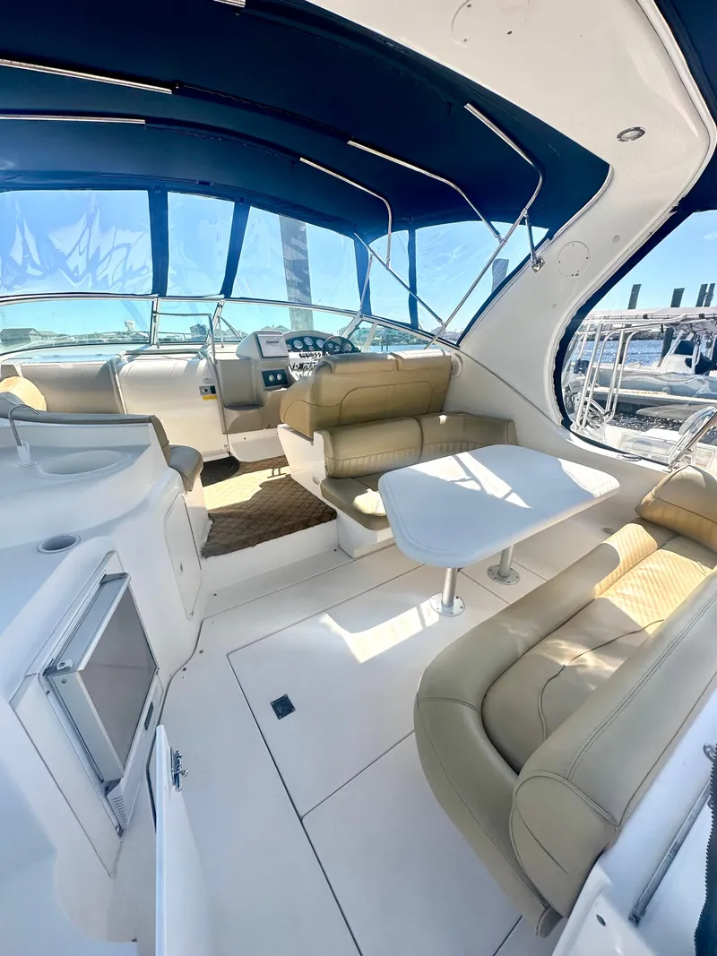 Slide: The Image of 2003 Cruisers Yachts 3372 Express interior with seating and table, featuring a sleek design. - 4