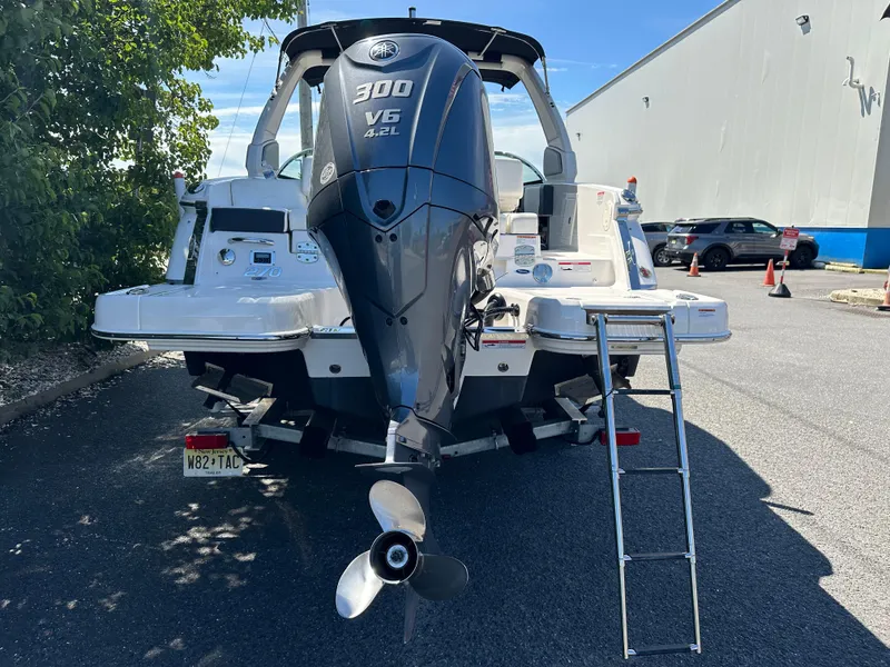 Slide: The Image of 2023 Chaparral 270 OSX boat with Yamaha 300 V6 engine, parked outdoors. - 12