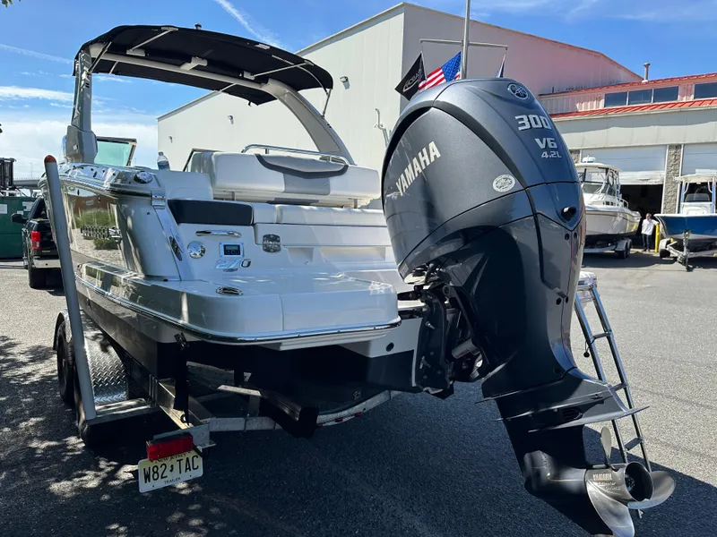Slide: The Image of 2023 Chaparral 270 OSX boat with Yamaha 300 V6 engine, parked outdoors. - 13