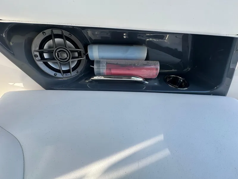 Slide: The Image of 2023 Chaparral 270 OSX boat interior with speaker and storage compartment. - 20