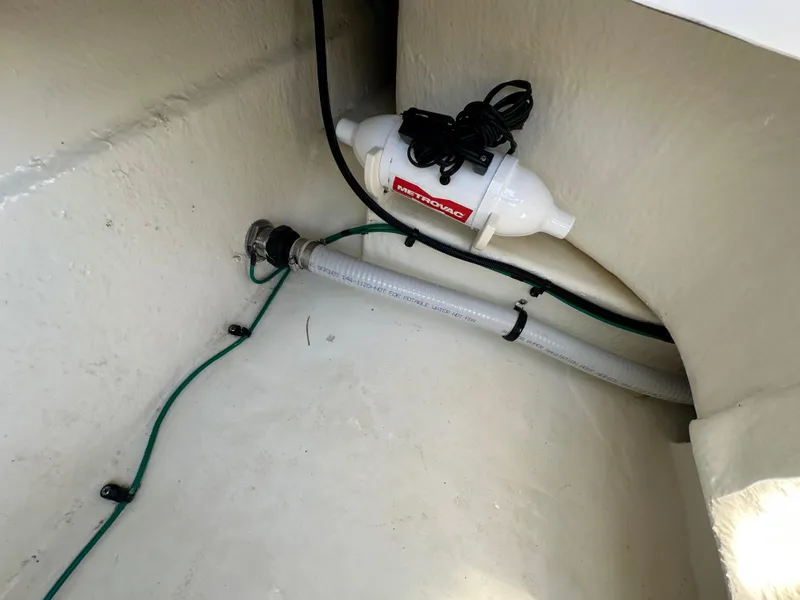 Slide: The Image of 2023 Chaparral 270 OSX boat interior showing plumbing and wiring components. - 22