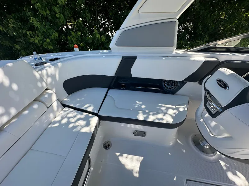Slide: The Image of 2023 Chaparral 270 OSX boat interior with sleek seating and modern design. - 24