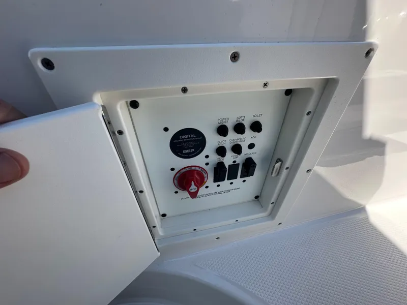 Slide: The Image of Control panel of 2023 Chaparral 270 OSX boat with switches and dials. - 25