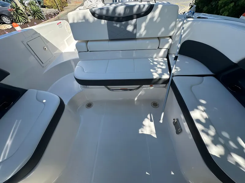 Slide: The Image of 2023 Chaparral 270 OSX boat interior with white seating and sleek design. - 28