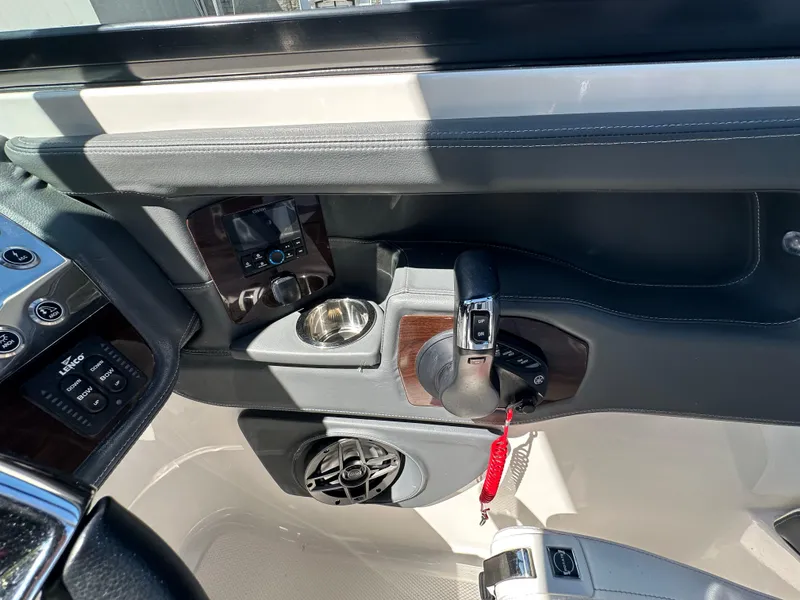 Slide: The Image of Interior view of 2023 Chaparral 270 OSX boat cockpit with controls and cup holder. - 29