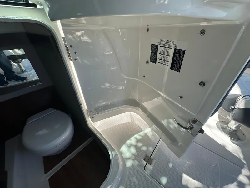 Slide: The Image of 2023 Chaparral 270 OSX boat interior with compact bathroom and toilet. - 30