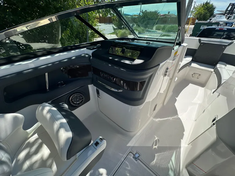 Slide: The Image of 2023 Chaparral 270 OSX boat interior with modern dashboard and seating. - 36