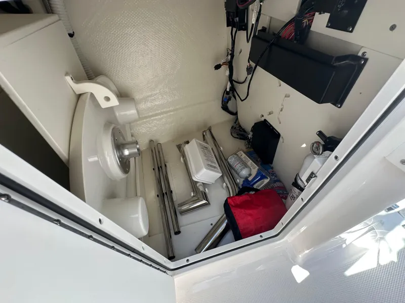 Slide: The Image of Storage compartment of 2023 Chaparral 270 OSX boat with equipment and accessories. - 39