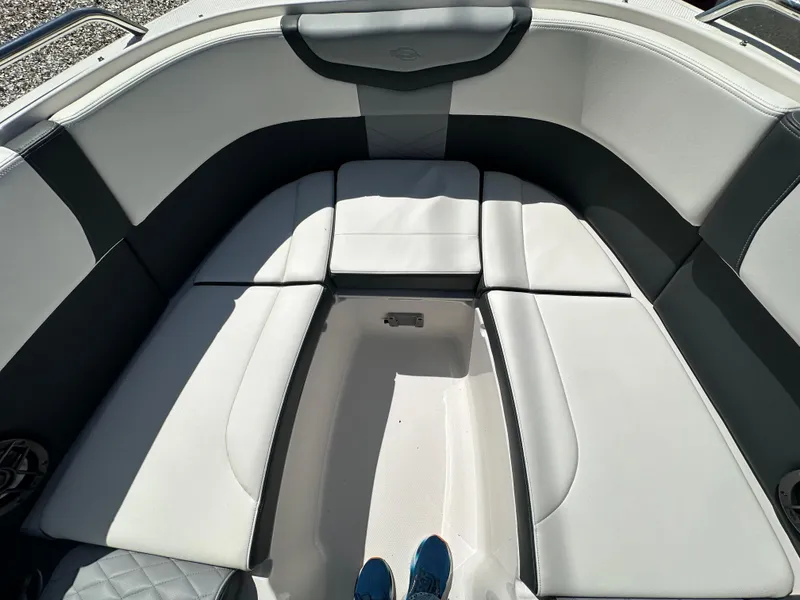 Slide: The Image of 2023 Chaparral 270 OSX boat interior with cushioned seating and storage area. - 40