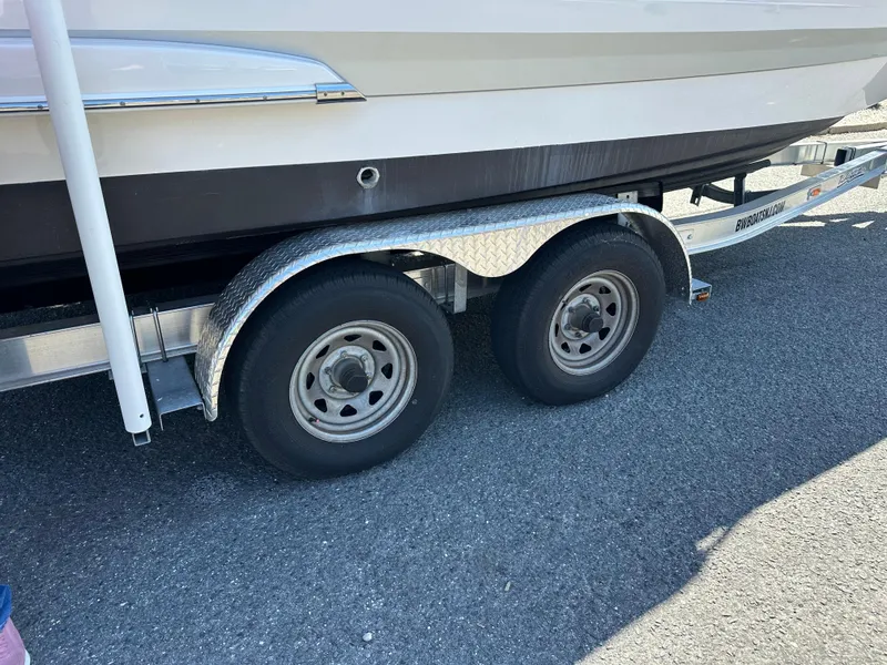Slide: The Image of Trailer wheels of 2023 Chaparral 270 OSX boat on asphalt surface. - 6