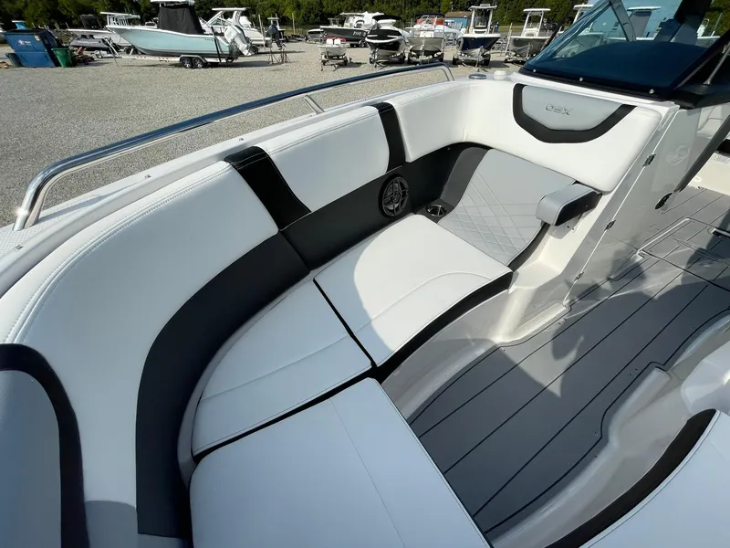 Slide: The Image of 2025 Chaparral 270 OSX boat interior with sleek white and black seating. - 12