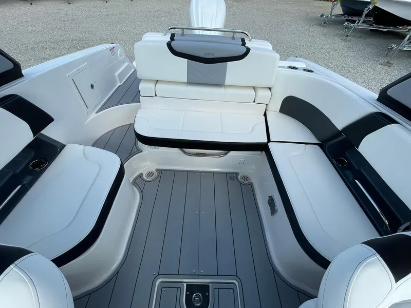 Slide: The Image of 2025 Chaparral 270 OSX boat interior with sleek white and black seating. - 28