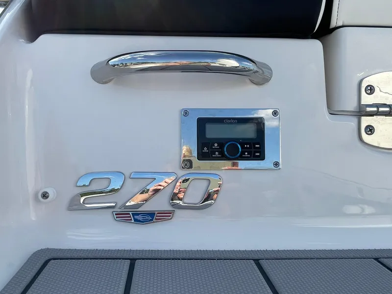 Slide: The Image of 2025 Chaparral 270 OSX boat dashboard with control panel and chrome handle. - 4