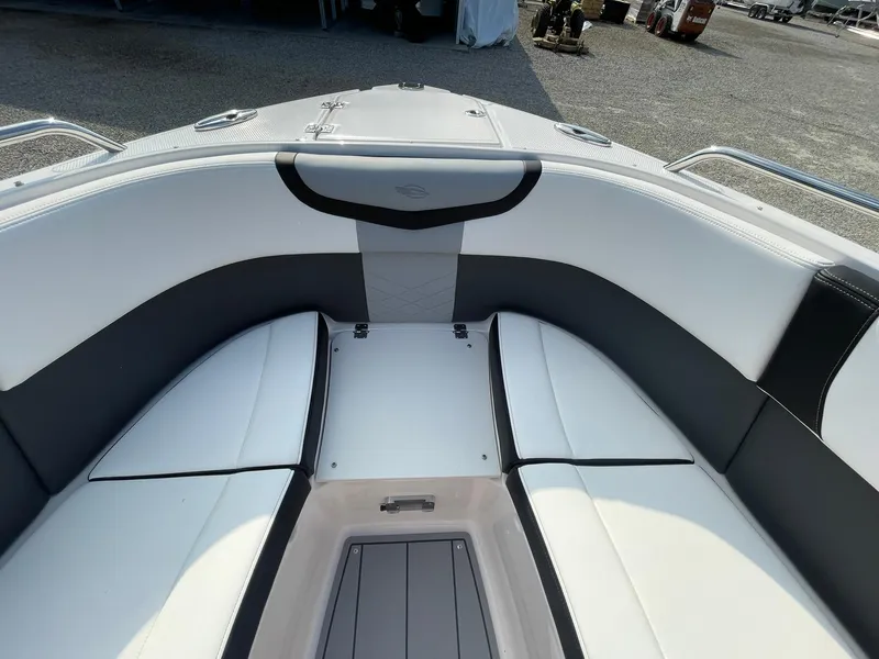 Slide: The Image of 2025 Chaparral 270 OSX boat interior with white and black seating. - 9