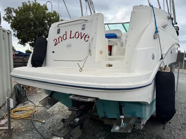 Slide: The Image of 2006 Bayliner 265 SD boat named "2nd Love" on land, rear view. - 17