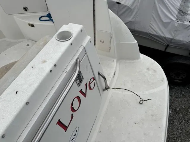 Slide: The Image of 2006 Bayliner 265 SD boat deck with "Love" text, featuring cup holder and storage compartment. - 7