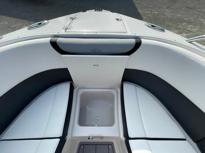 Slide: The Image of Interior view of 2025 Chaparral 270 OSX boat, featuring cushioned seating and storage compartment. - 10