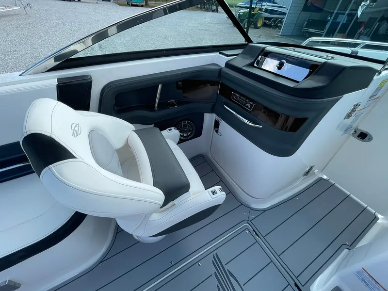 Slide: The Image of 2025 Chaparral 270 OSX boat interior with sleek helm and comfortable seating. - 19