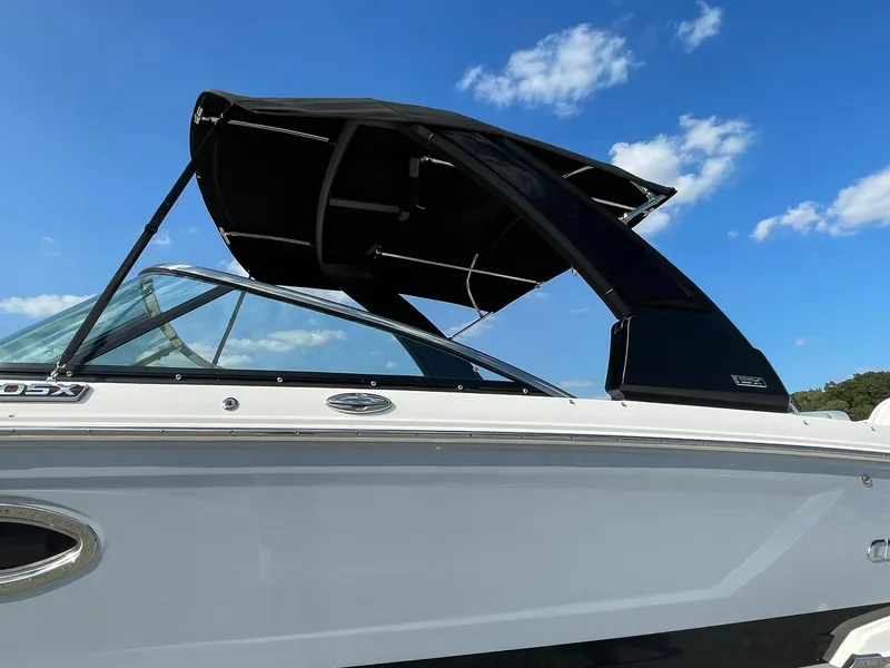 Slide: The Image of 2025 Chaparral 270 OSX boat with sleek design and black canopy under blue sky. - 3