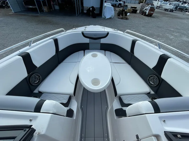 Slide: The Image of 2025 Chaparral 270 OSX boat interior with white seating and central table. - 30