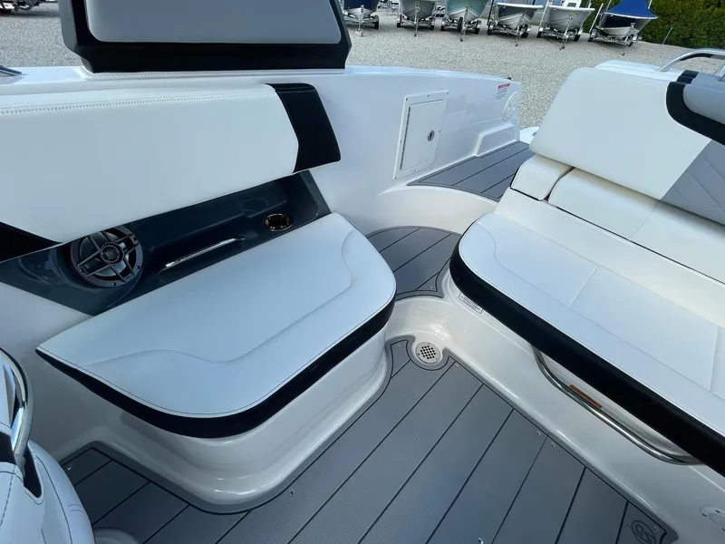Slide: The Image of 2025 Chaparral 270 OSX boat interior with white seating and modern design. - 32