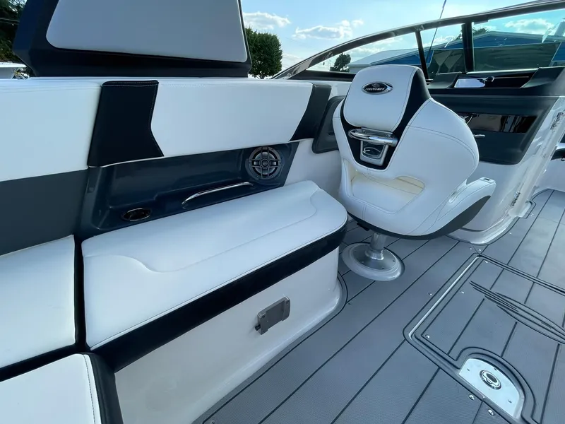 Slide: The Image of 2025 Chaparral 270 OSX boat interior with white seating and modern design. - 36