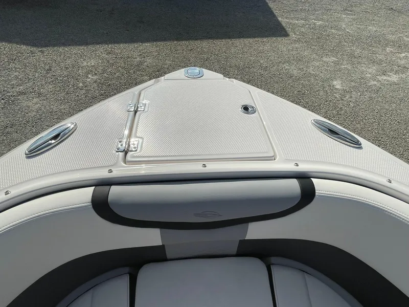 Slide: The Image of 2025 Chaparral 270 OSX boat bow with sleek design and storage hatch. - 5