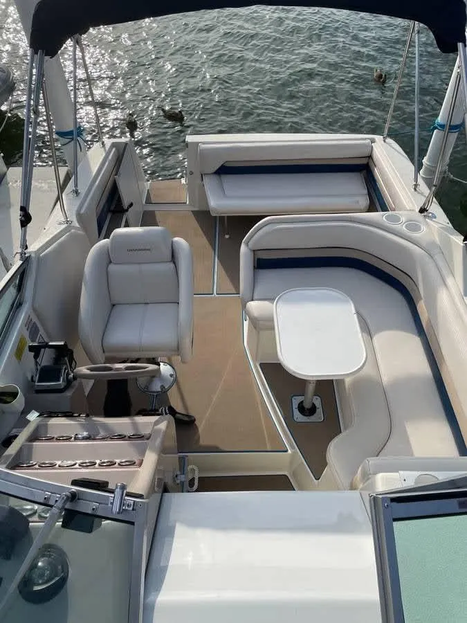 Slide: The Image of 1998 Chaparral 270 Signature boat interior with seating and table, overlooking water. - 11