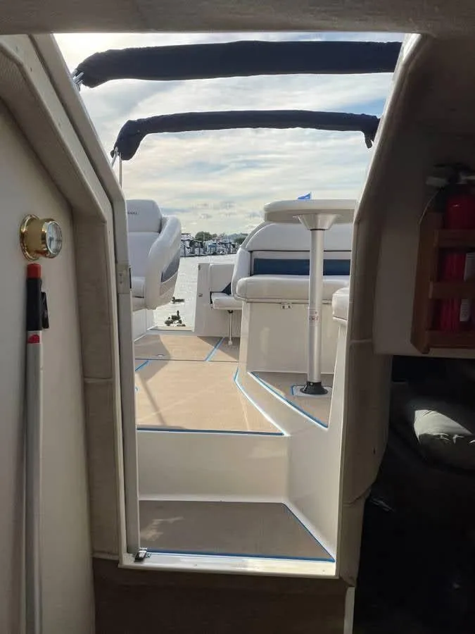 Slide: The Image of 1998 Chaparral 270 Signature boat interior with seating and open deck view. - 12