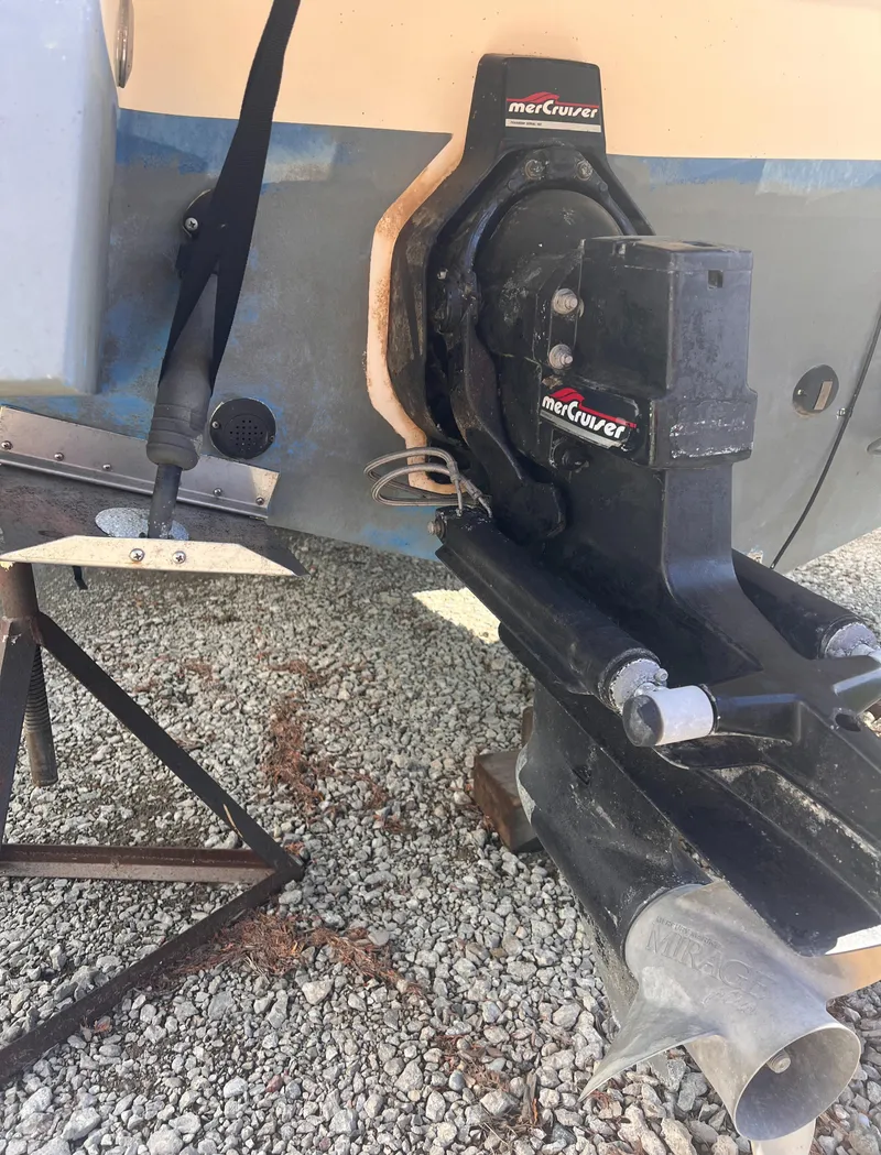 Slide: The Image of 1998 Chaparral 270 Signature boat with MerCruiser outdrive on gravel surface. - 17