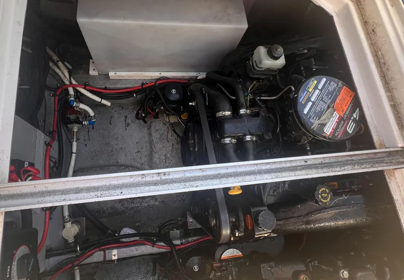 Slide: The Image of Engine compartment of a 1998 Chaparral 270 Signature boat, showing mechanical components and wiring. - 23