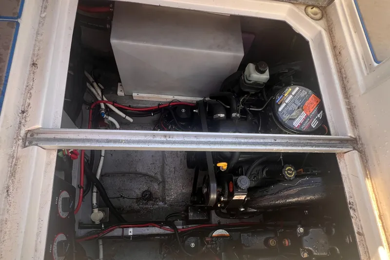 Slide: The Image of Engine compartment of a 1998 Chaparral 270 Signature boat, showing mechanical components and wiring. - 24