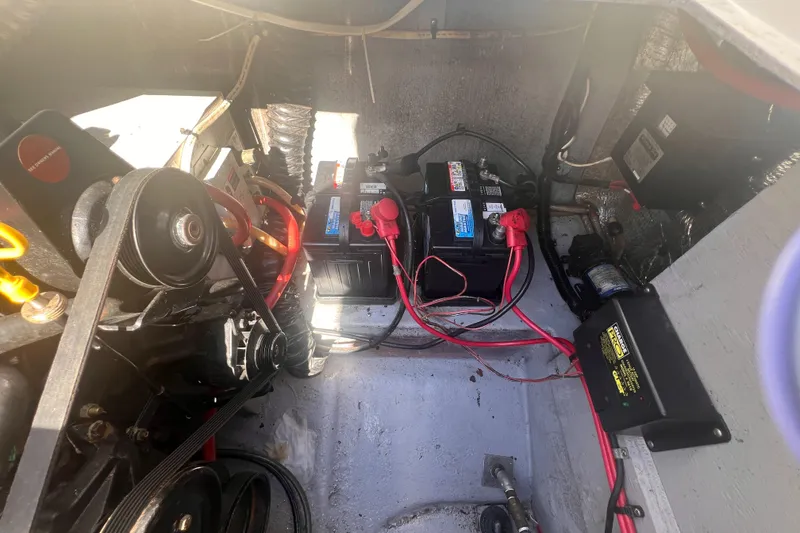 Slide: The Image of Engine compartment of a 1998 Chaparral 270 Signature boat with visible batteries and wiring. - 27