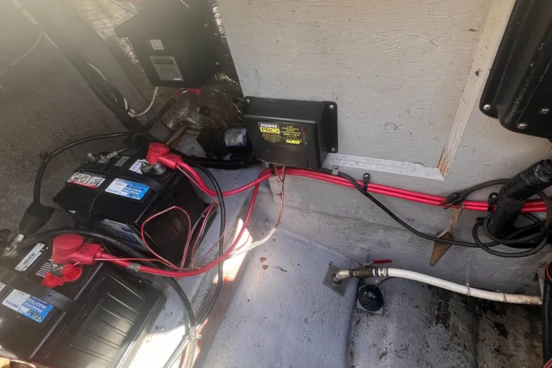 Slide: The Image of Battery compartment of 1998 Chaparral 270 Signature boat with wiring and charger. - 29