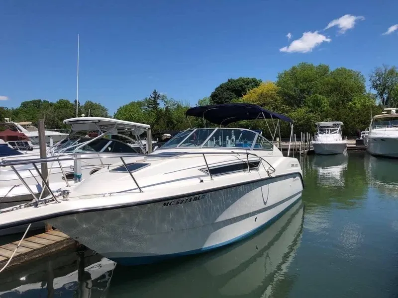 Slide: The Image of 1998 Chaparral 270 Signature boat docked in a marina under a clear blue sky. - 3
