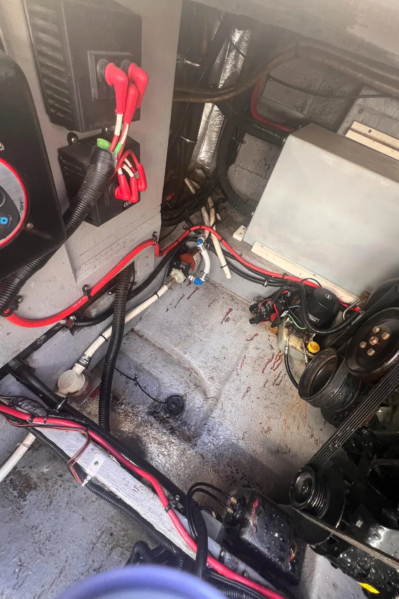 Slide: The Image of Engine compartment of a 1998 Chaparral 270 Signature boat with visible wiring and components. - 31