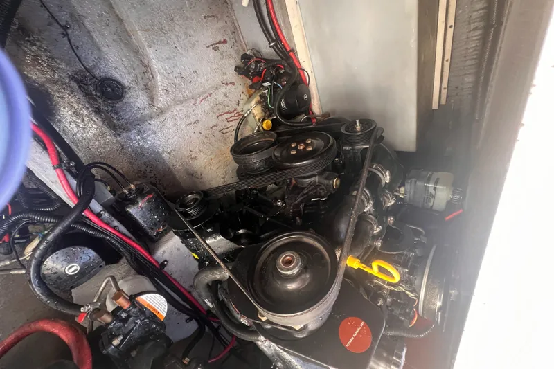 Slide: The Image of Engine compartment of a 1998 Chaparral 270 Signature boat, showing mechanical components and wiring. - 32