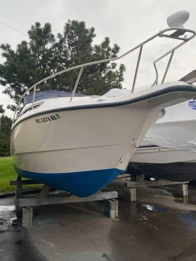 Slide: The Image of 1998 Chaparral 270 Signature boat on a stand, with trees in the background. - 5