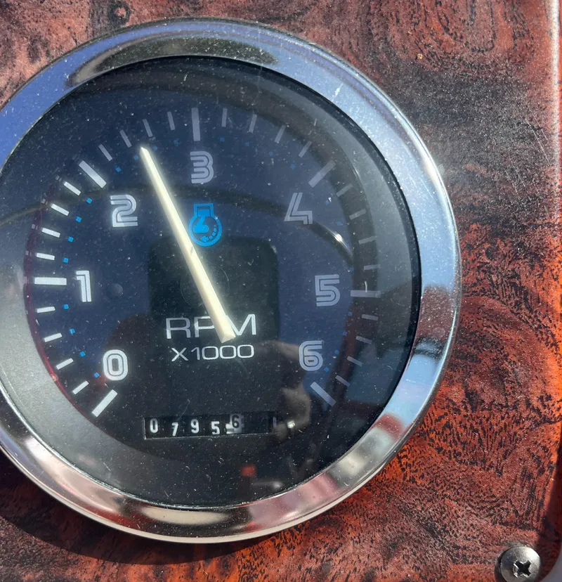 Slide: The Image of 1998 Chaparral 270 Signature RPM gauge displaying 795.6 hours on a wooden dashboard. - 9