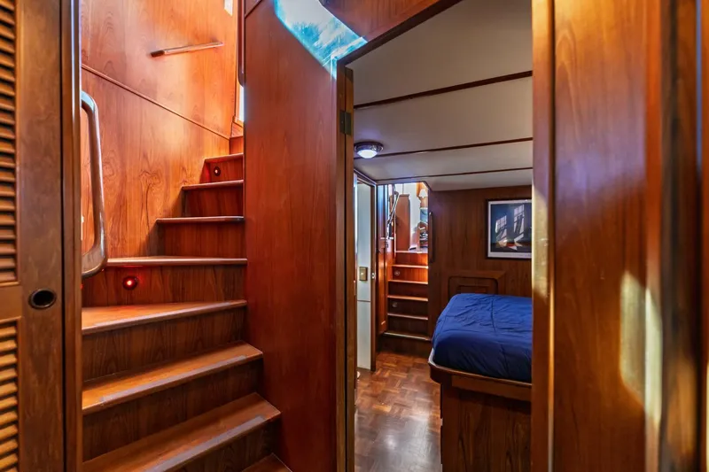 Slide: The Image of Interior of 1992 DeFever 49 Pilothouse with wooden stairs and cozy cabin. - 11