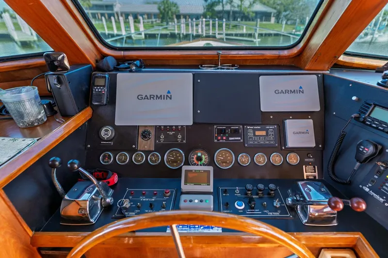 Slide: The Image of 1992 DeFever 49 Pilothouse helm with Garmin navigation, gauges, and controls. - 15