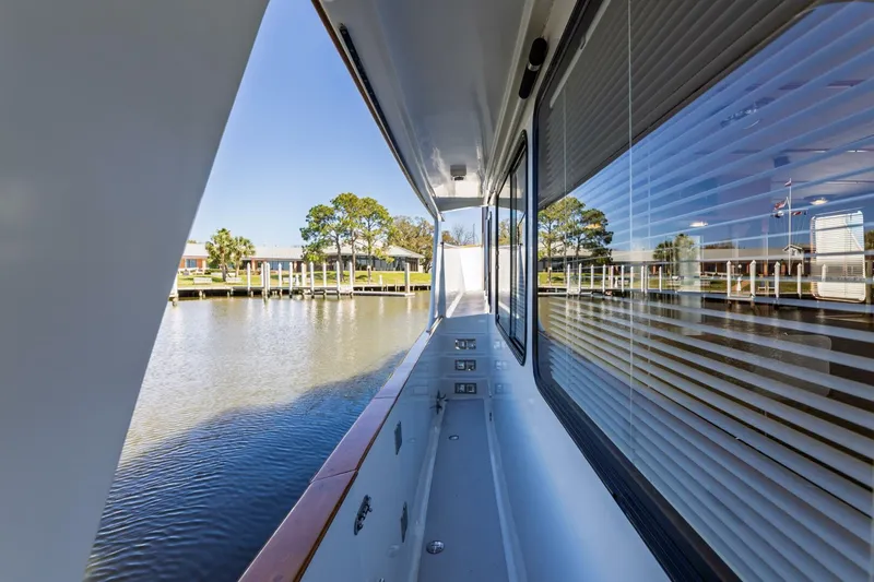 Slide: The Image of Side deck view of 1992 DeFever 49 Pilothouse yacht, reflecting water and marina scenery. - 18