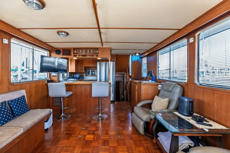 Slide: The Image of Interior of 1992 DeFever 49 Pilothouse yacht with wood paneling and modern furnishings. - 2