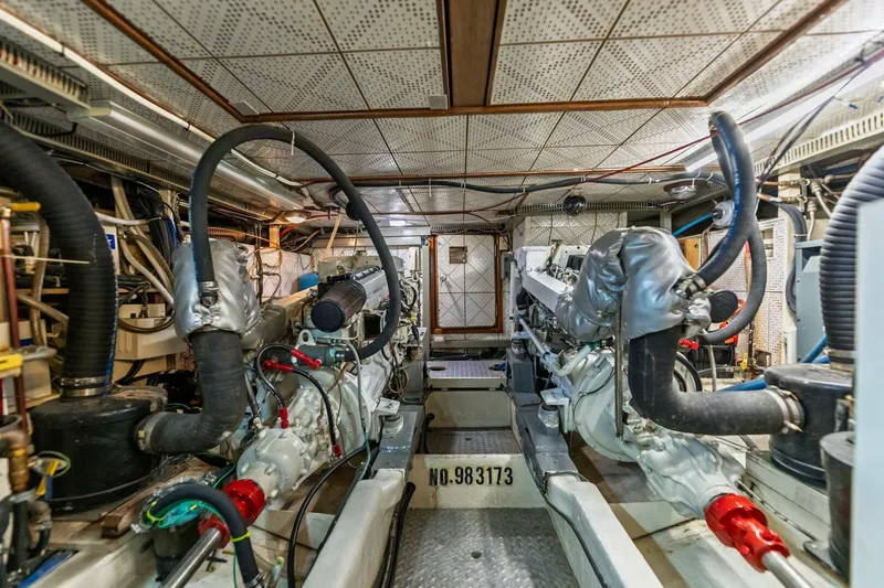 Slide: The Image of Engine room of 1992 DeFever 49 Pilothouse with dual engines and complex piping system. - 26