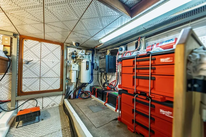Slide: The Image of Engine room of 1992 DeFever 49 Pilothouse with organized tools and equipment. - 27